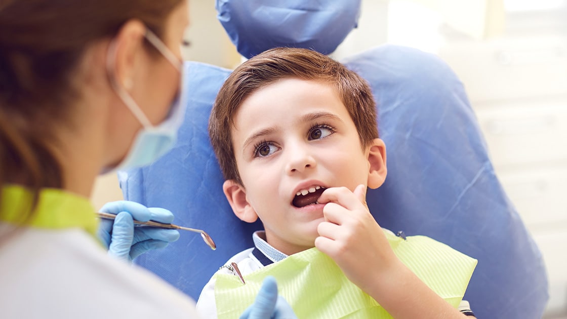 Boy in Dental Chair with Assistant