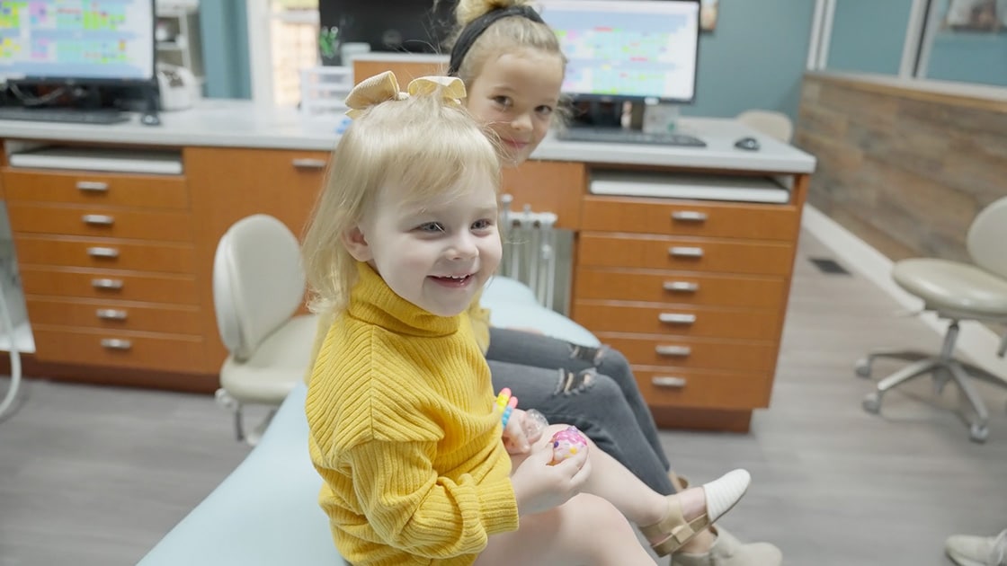 kids smiling in dentist office
