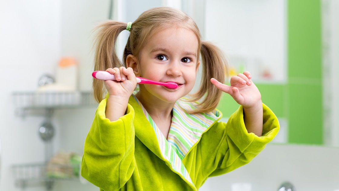 Girl Brushing Her Teeth Phot