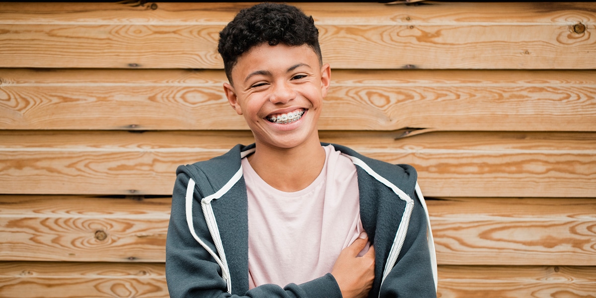 Teenage boy wearing a hoodie smiling