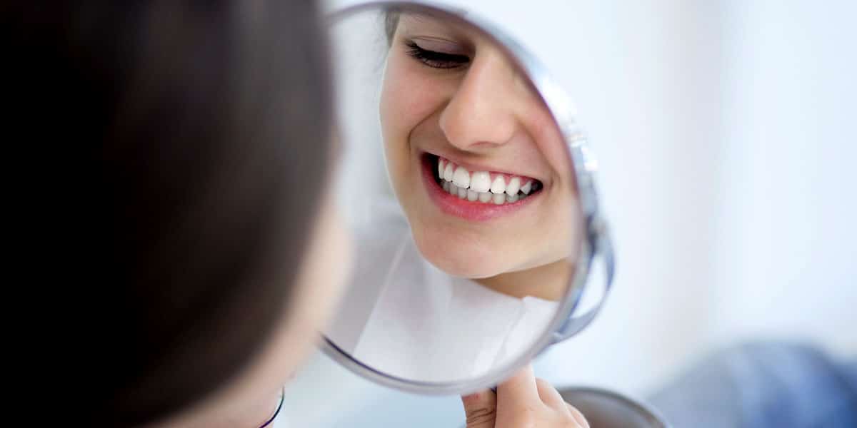 Girl Smiling in Mirror Photo